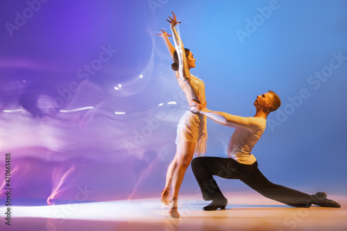 Fotografie, Obraz Young graceful dancers, flexible man and woman dancing ballroom dance isolated o