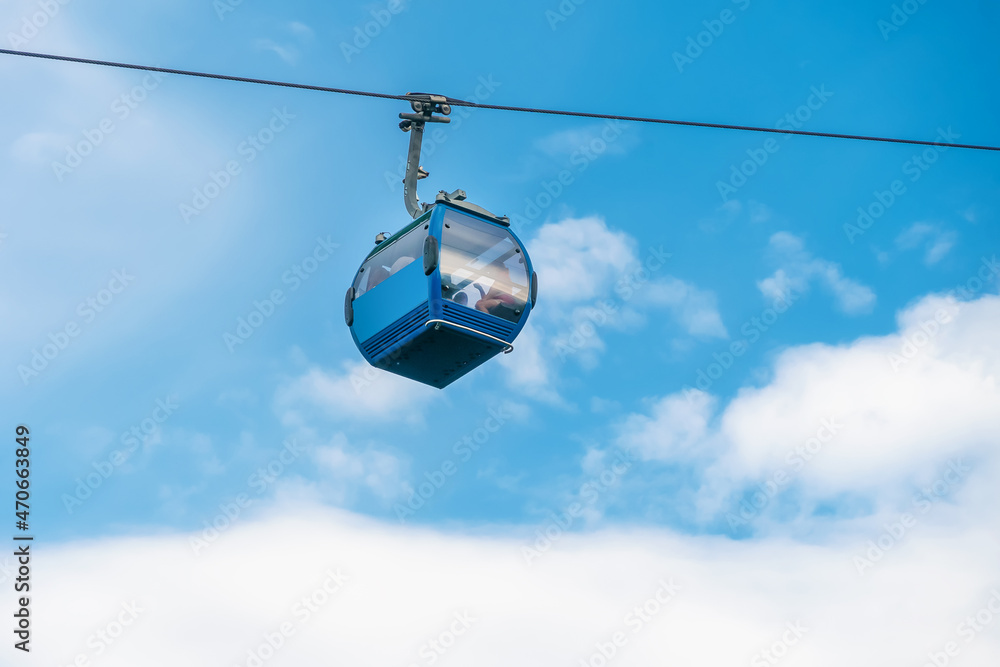 Close-up of the cableway cab on the background of the sky and clouds, funicular Close-up of the cableway cab on the background of the sky and clouds, funicular