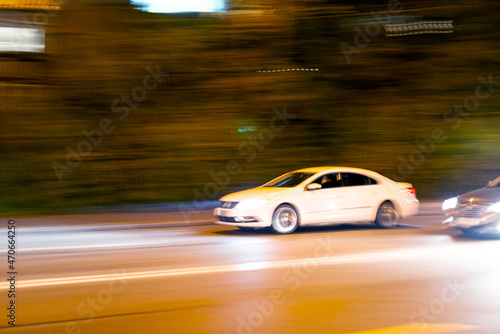 Blurred car traffic on the background of the road in the city at night