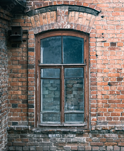 An old bricked up window in old brick house