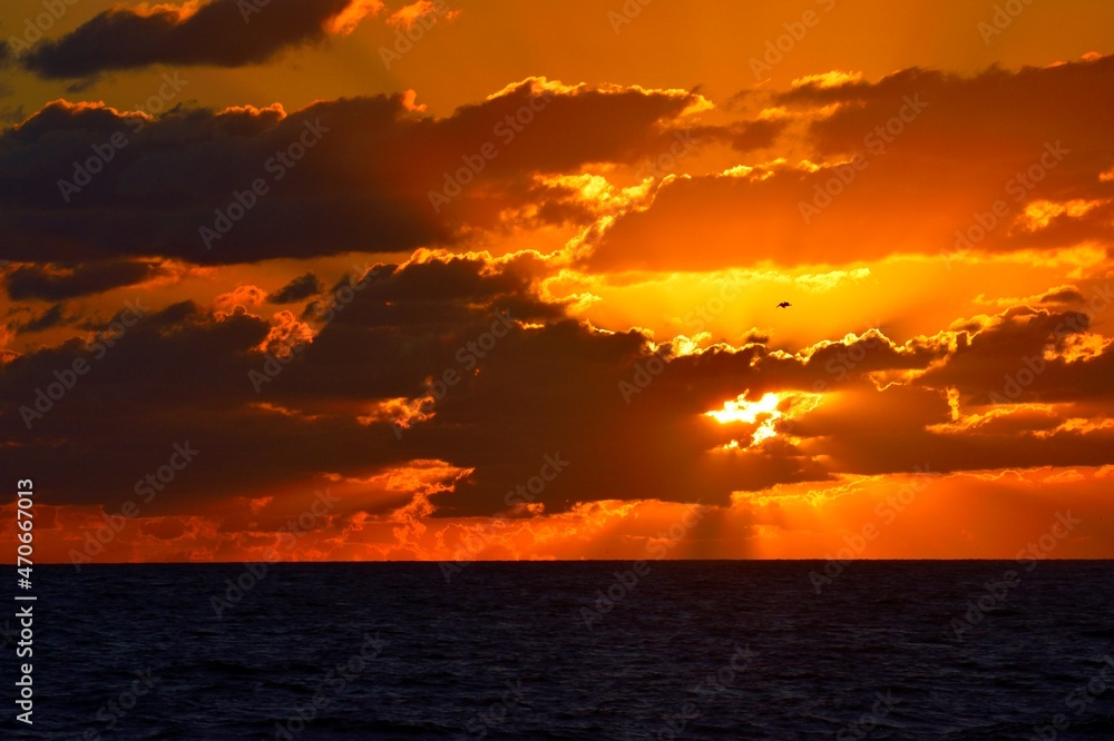 Vibrant orange colors sunrise over the ocean background.