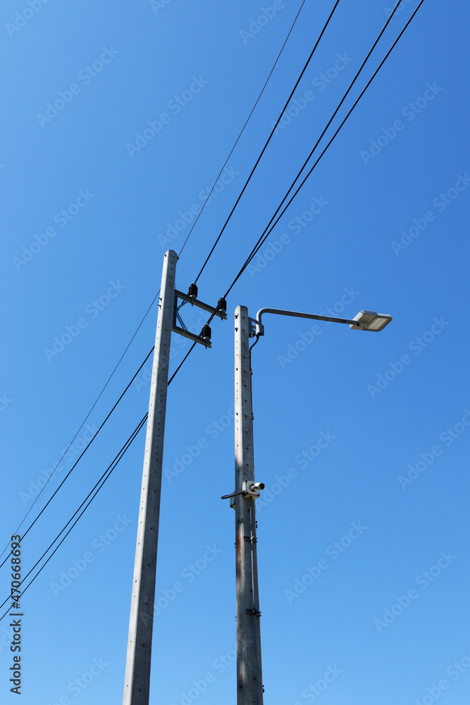 LED street lamps are mounted on tall concrete light poles with background of the sky. LED street lamps are mounted on tall concrete light poles with background of the sky.