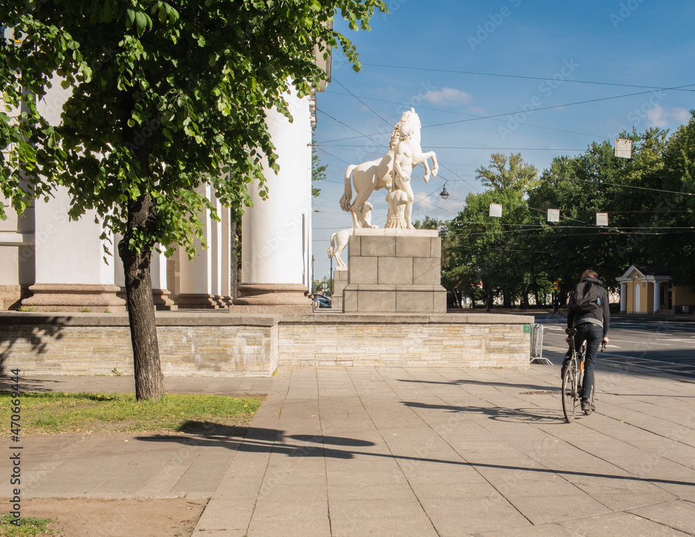Cyclist on St. Isaac's Square in St. Petersburg, view from the back.