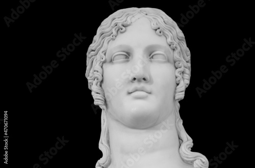 Gypsum copy of ancient statue Venus head isolated on black background. Plaster sculpture woman face