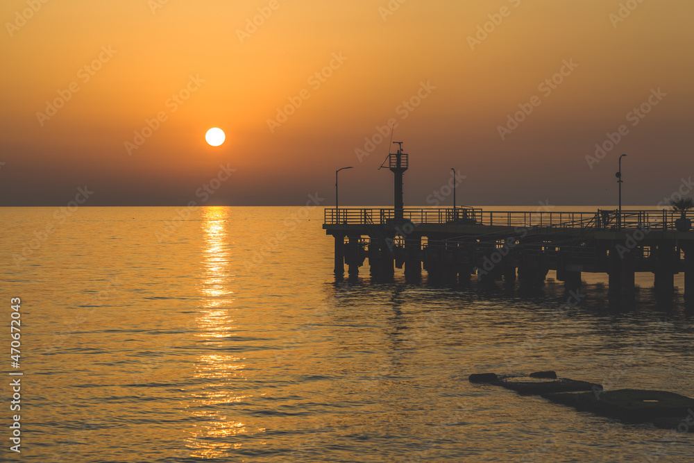 view of the sea pier at sunset