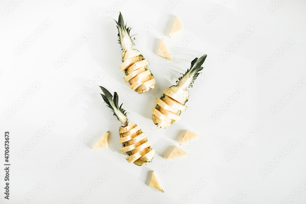 Naklejka premium Sliced pineapple on white background. Flat lay, top view tasty fruit arrangement