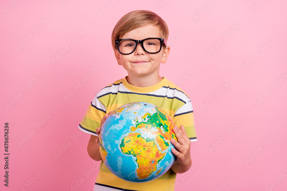 Photo of small positive happy cheerful boy lesson classroom hold globe earth isolated on pink color background Photo of small positive happy cheerful boy lesson classroom hold globe earth isolated on pink color background