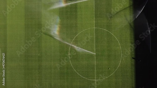 Watering football field before professional football game, lawn care, irrigation of grass before soccer match concept. 4k high quality cinematic hdr footage 