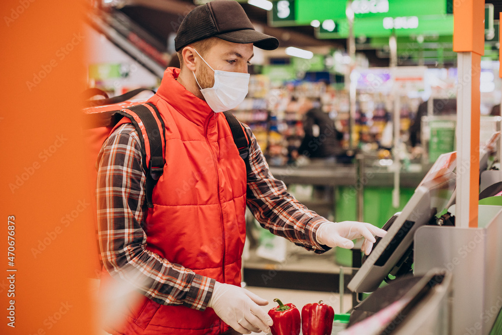 Food delivery man buying products at grocery store Food delivery man buying products at grocery store