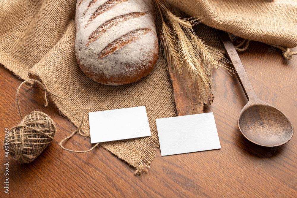 Blank business cards on the wooden background with bread, bakery