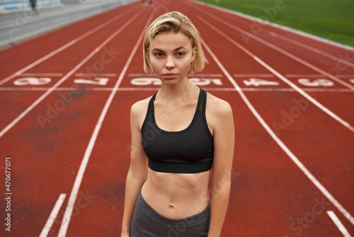 Young caucasian sports woman on stadium treadmill