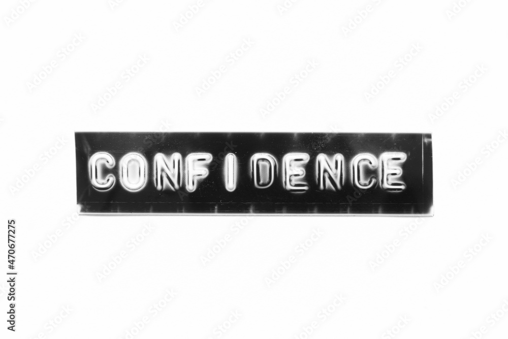 Embossed letter with word confidence in black banner on white paper background Embossed letter with word confidence in black banner on white paper background