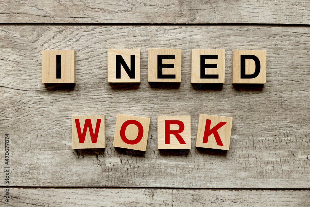 Fototapeta premium I NEED WORK. wooden cubes on a wooden background. three wood blocks