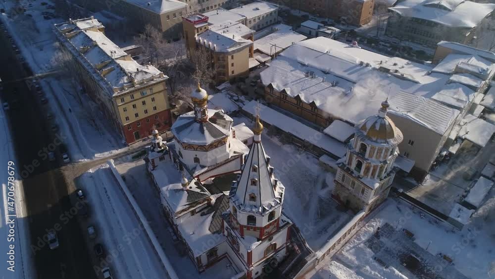 Cathedral of the Epiphany of the Blessed Virgin in Irkutsk. Aerial drone flight. In winter, the Russian city is covered with ice and snow. Cathedral of the Epiphany of the Blessed Virgin in Irkutsk. Aerial drone flight. In winter, the Russian city is covered with ice and snow.