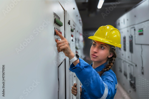 A female engineer inspects the equipment and double-checks the security system's configuration. 