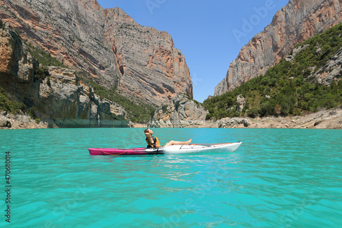 Woman relaxing on kayak resting in a lake on vacation © Antonioguillem