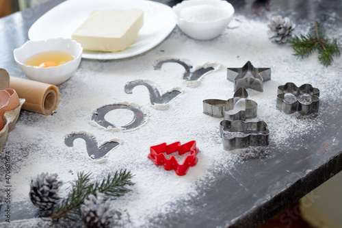 making Christmas cookies. molds, eggs, butter, sugar. inscription 2022 flour.