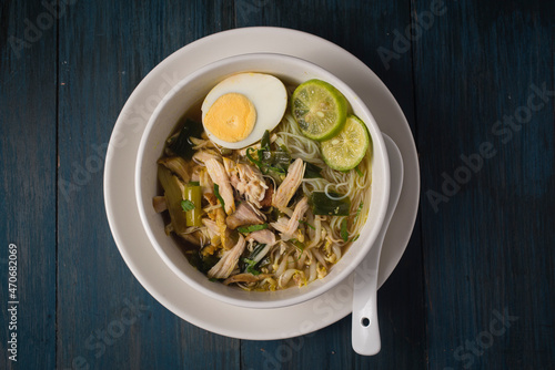 Chicken Soto or Soto Ayam in Indonesia. Soto ayam is a traditional Indonesian dish which uses ingredients such as chicken, vermicelli, bean sprout with turmeric as main ingredient add in the broth. photo