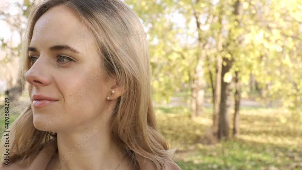 Portrait of young attractive blonde woman walking in the autumn park on sunset Portrait of young attractive blonde woman walking in the autumn park on sunset
