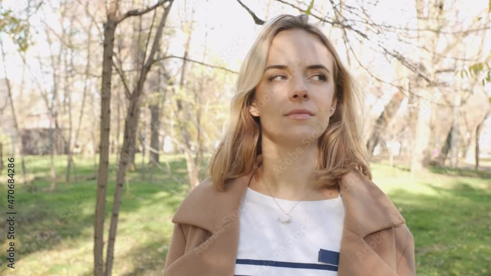 Portrait of young attractive blonde woman walking in the autumn park on sunset Portrait of young attractive blonde woman walking in the autumn park on sunset
