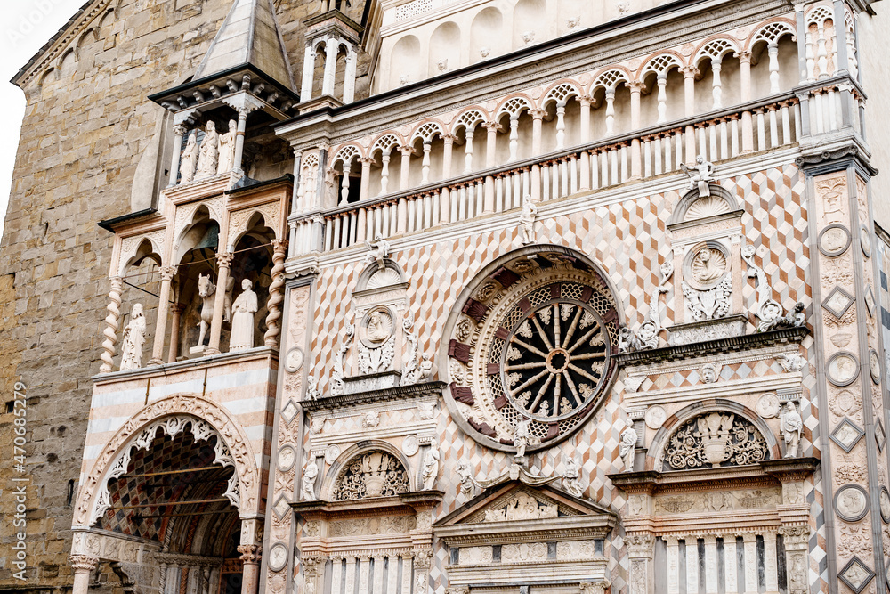 Statues, columns and stucco moldings on the facade of the Colleoni Chapel. Bergamo, Italy