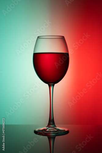 a glass of red wine on a two-tone background