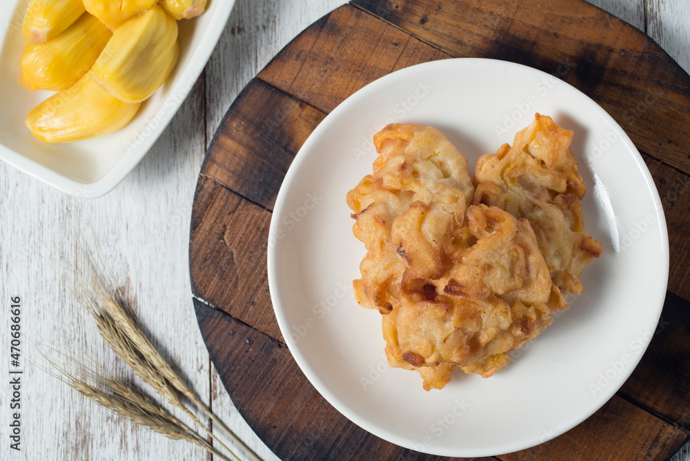Jack fruit fritter, traditional yet delicious snacks for tea or coffee time and it's also good brunch. High view with rustic white background Jack fruit fritter, traditional yet delicious snacks for tea or coffee time and it's also good brunch. High view with rustic white background
