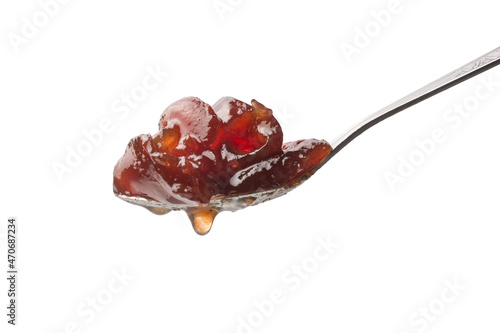 Photos spoonful of wood apple jam isolated on white background, closeup