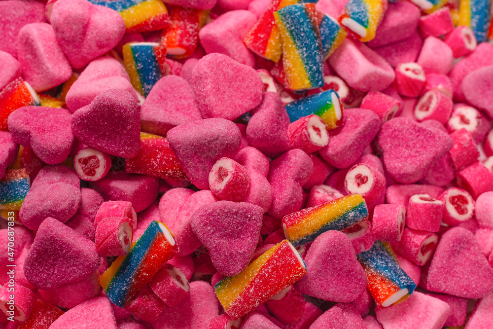 Assorted tasty gummy candies. Pink jelly sweets background.