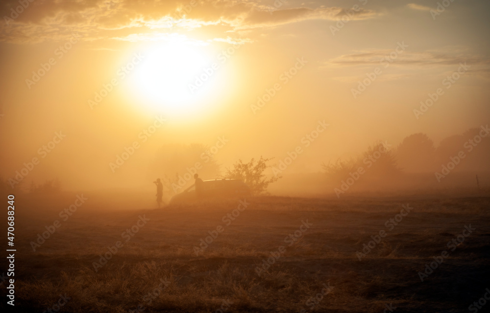 Sandstorm in the desert against the background of the sun Sandstorm in the desert against the background of the sun