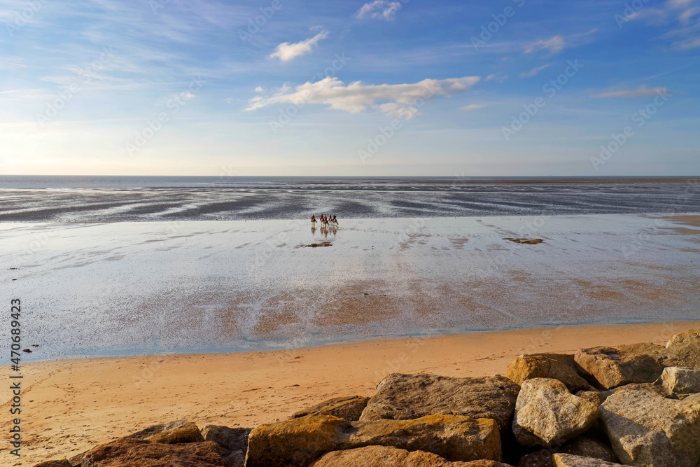 Fototapeta premium Horsemen in the Cotentin coast. Hauteville-sr-Mer beach