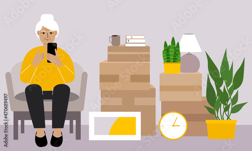 Grandmother at home with a mobile, phone sits in a chair. The concept of online registration of delivery of boxes, goods and assistance in moving.