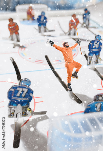 Photography A real hockey player on the table hockey court emotionally celebrates a goal amo