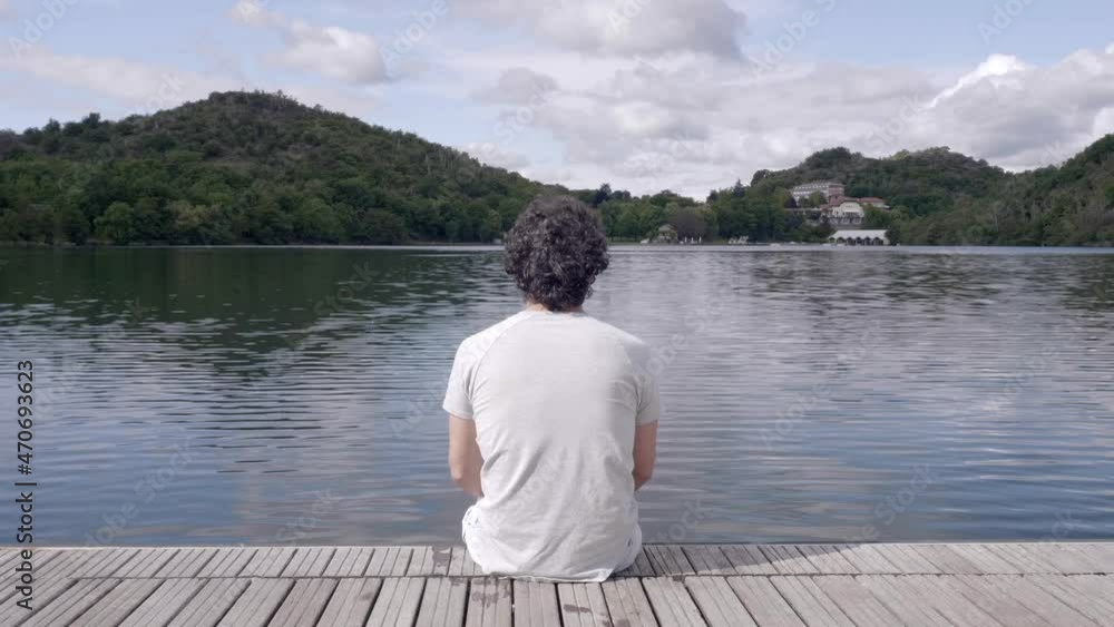 Man enjoys the wonderful landscape by the lake. Video 4K Man enjoys the wonderful landscape by the lake. Video 4K