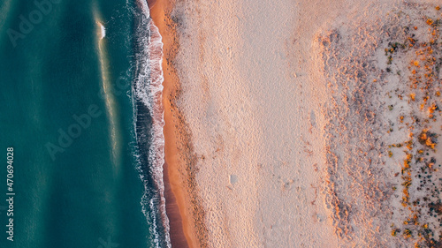 Aerial view of seashore and wild sandy beach. Natural background, drone photography. Directly above.