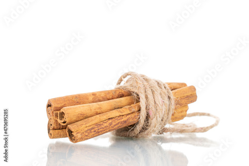 Several fragrant dry cinnamon sticks, close-up, isolated on white.