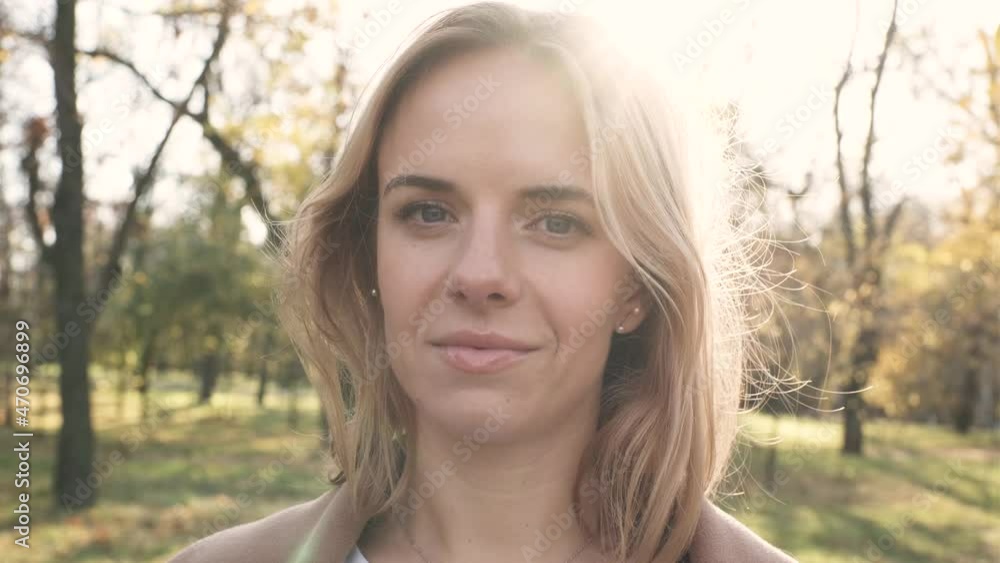 Portrait of young attractive blonde woman walking in the autumn park on sunset Portrait of young attractive blonde woman walking in the autumn park on sunset