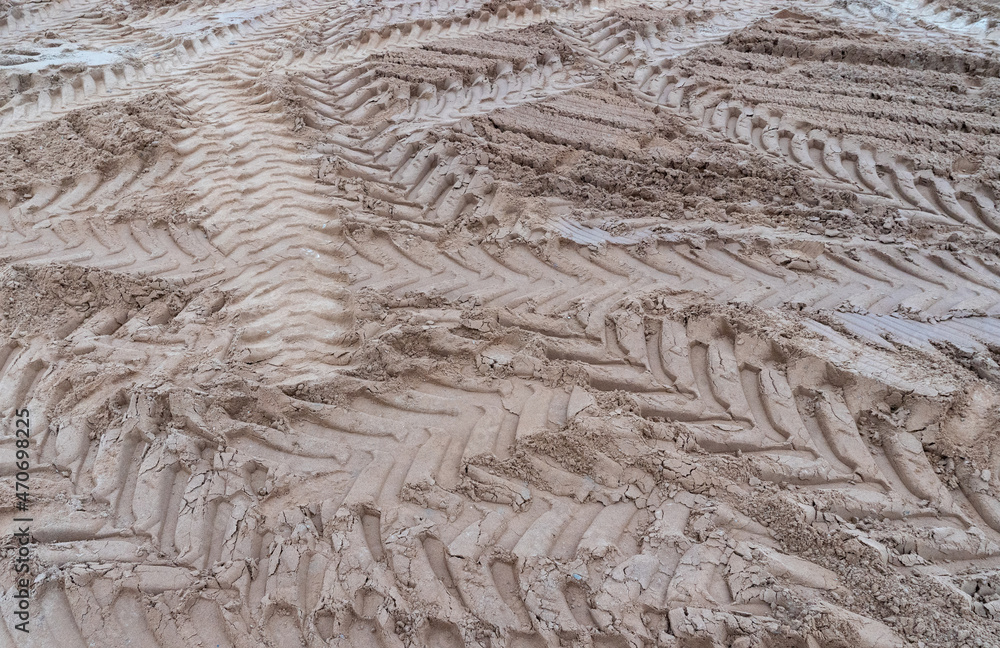 Photo of brown earth and sand with traces of construction equipment Photo of brown earth and sand with traces of construction equipment