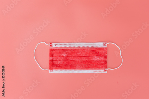 red medical mask on pink background