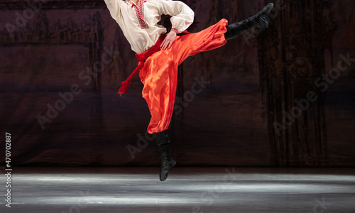 Closeup of classical ballet male dancer dancing hopak photo