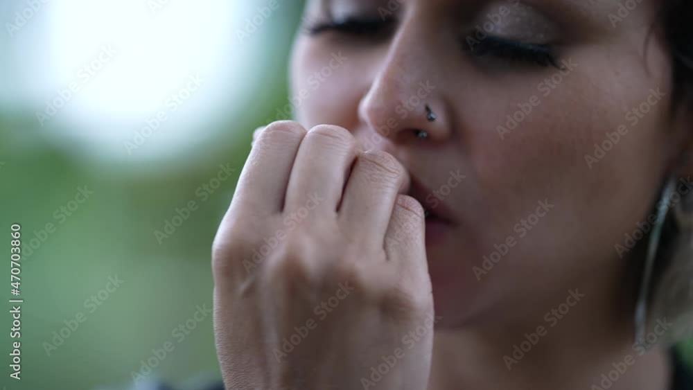Anxious woman biting nail outside, nervous girl bites nail Anxious woman biting nail outside, nervous girl bites nail