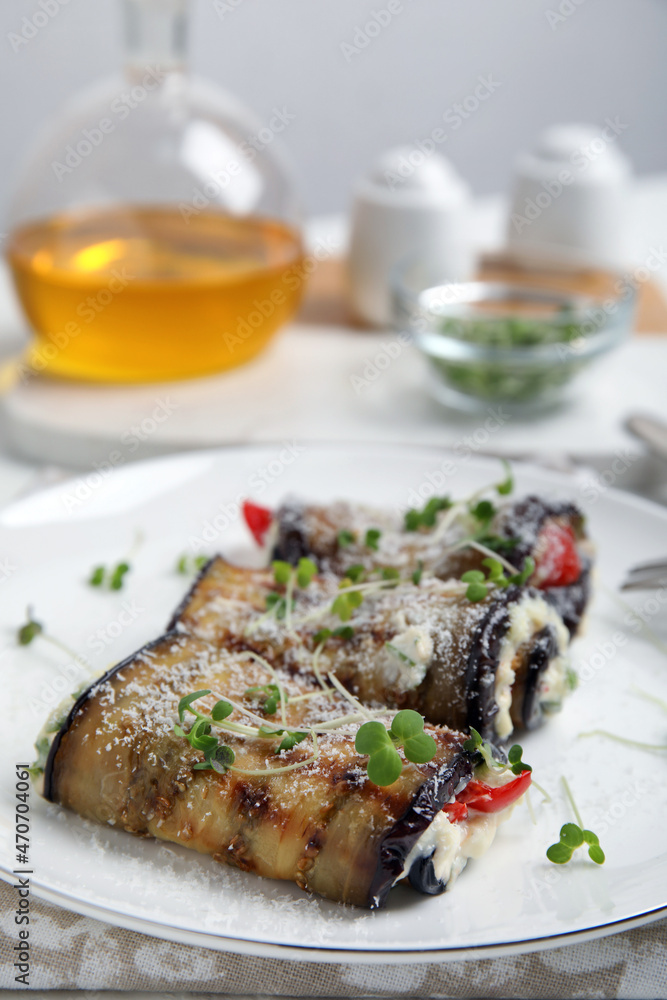 Delicious baked eggplant rolls served on table, closeup