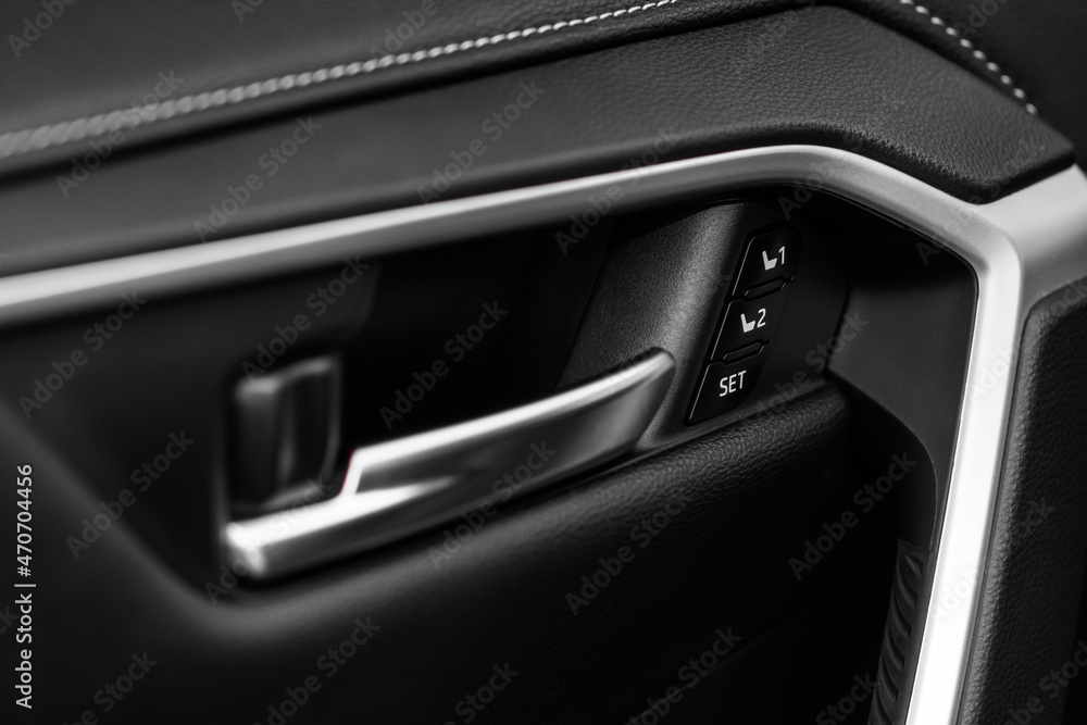 Electric car seat adjustment control panel close up view. Adjustable car seat position buttons on the door. Car interior. Electric car seat adjustment control panel close up view. Adjustable car seat position buttons on the door. Car interior.