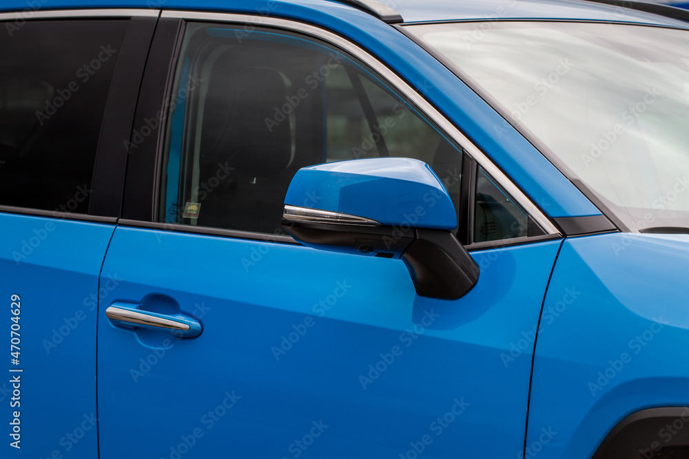 Close up front view of car side mirror. Front rear view mirror on the car window. Car exterior details.