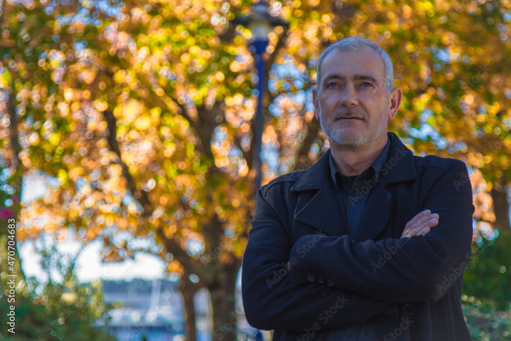 man in coat posing in autumn background man in coat posing in autumn background