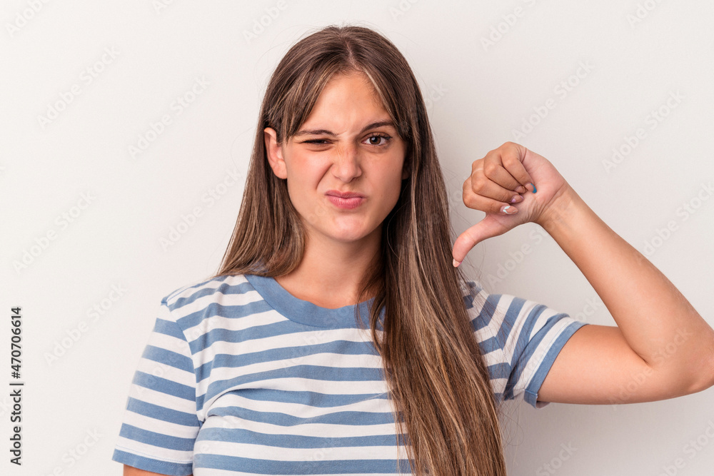 Young caucasian woman isolated on white background showing thumb down, disappointment concept. Young caucasian woman isolated on white background showing thumb down, disappointment concept.