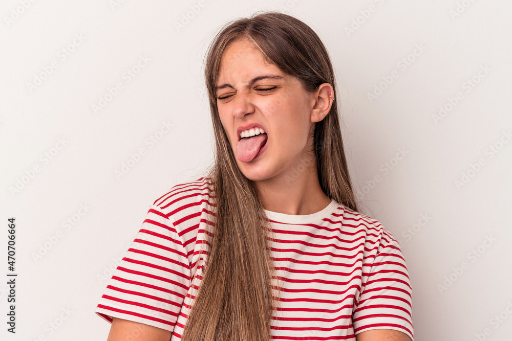 Young caucasian woman isolated on white background funny and friendly sticking out tongue. Young caucasian woman isolated on white background funny and friendly sticking out tongue.