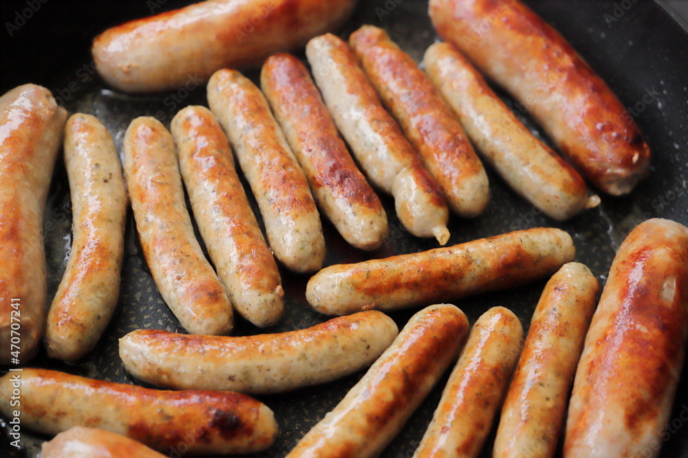 lots of delicious fried sausages in the pan lots of delicious fried sausages in the pan