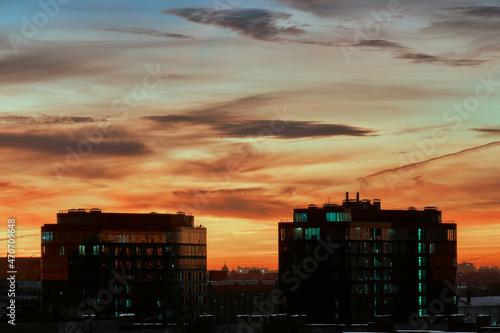 The city at sunset . Two twin buildings against the background of the evening sky .