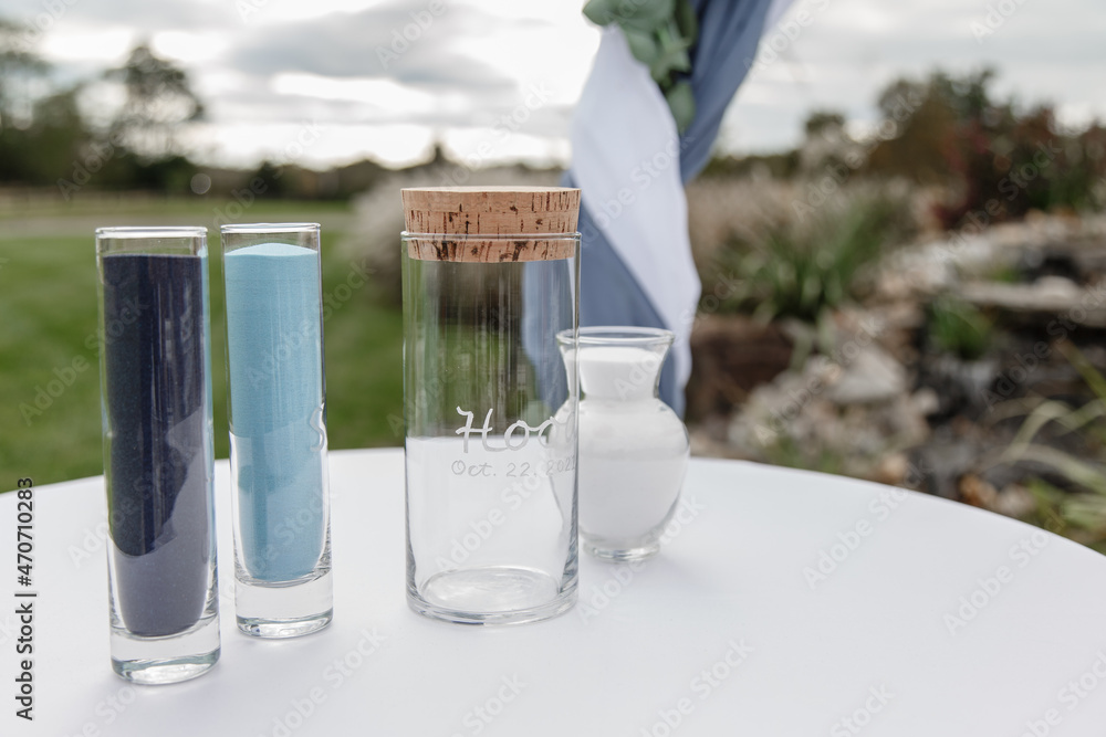 Sand ceremony on wedding glass vases for bride and groom A view of